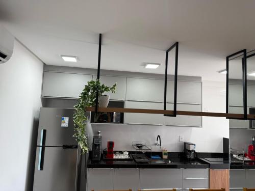 a kitchen with a stainless steel refrigerator at Apart Moderno Proximo ao Mar in Vila Velha