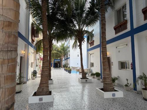 a hallway with palm trees in a building at فلل الخالدية in Jeddah