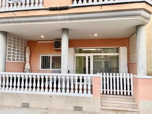 a house with a white railing and a porch at Planta baja en pleno centro de la playa in Moncófar