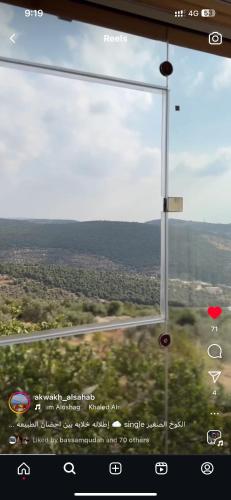 an open window with a view of a highway at Alsaba Huts in Ajloun