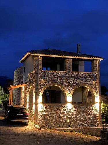 a building with a car parked in front of it at Horizon Villa Mani - Seaview Family Friendly House in Stoupa