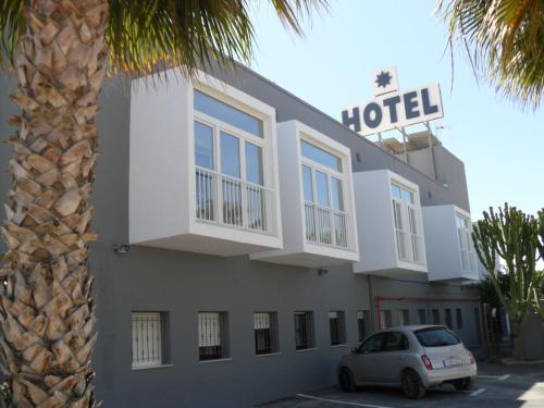 a hotel with a car parked in front of it at Hotel Lo Monte in Pilar de la Horadada