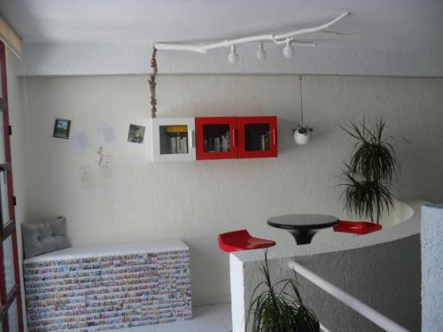 a living room with a table and red cabinets at Hotel Lo Monte in Pilar de la Horadada