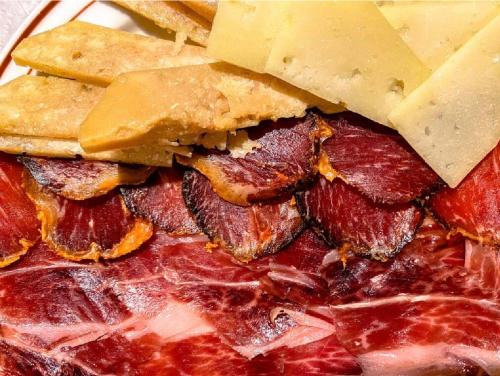 a close up of a sandwich with cheese and bread at Apartamento Henko in Huelva