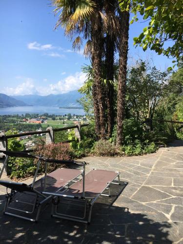 a table and bench on a patio with a view at Casa Ai Lupi with Panoramic view in Gordola