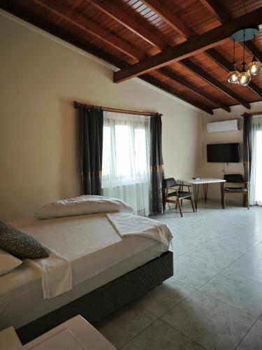 a bedroom with a bed and a table in a room at Adakonak Urla in Urla