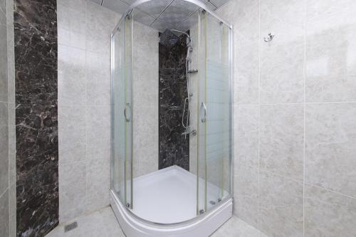 a shower with a glass door in a bathroom at Adakonak Urla in Urla