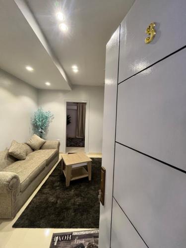 a living room with a couch and a table at Triple Garden Studios and apartments in Cairo