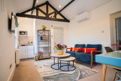 a living room with a couch and a table at Highway Cottage - Mickleham in Mickleham