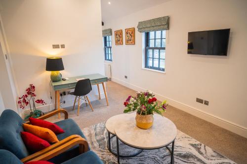 a living room with a couch and a table at Highway Cottage - Mickleham in Mickleham