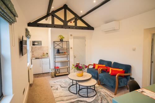 a living room with a couch and a table at Highway Cottage - Mickleham in Mickleham