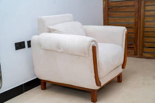 a white chair sitting in a living room at Unit number 1 in Nkunjila