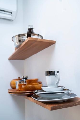 a shelf with plates and a coffee cup on it at Unit number 1 in Nkunjila