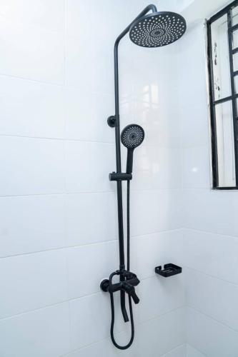 a shower in a bathroom with a black shower head at Unit number 1 in Nkunjila