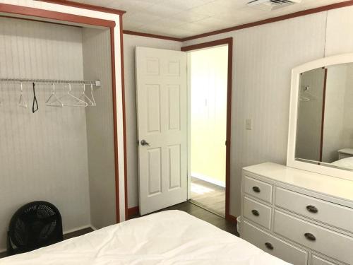 a bedroom with a bed and a mirror and a dresser at Brant Beach Oceanside Pet Friendly Second Floor Duplex Ocean Views 14018 in Brant Beach