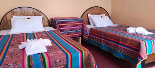 Postel nebo postele na pokoji v ubytování Paqariy lodge