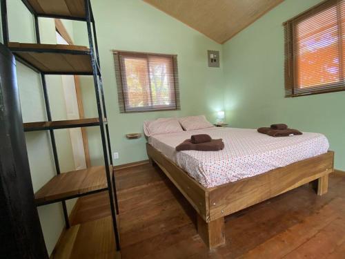 a bedroom with a bunk bed and a ladder at Casa MILUCO Maison privée vue sur mer in Puerto Viejo