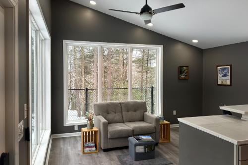 a living room with a chair and a window at Modern Nimitz Cabin on 19 Acres with Fireplace and WiFi in Nimitz
