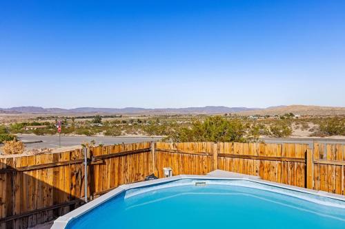 a swimming pool in front of a wooden fence at Casa Homestead Hemel in Twentynine Palms