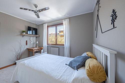 a bedroom with a white bed and a window at Italian Experience-La Casa Del Saggio in Pavia