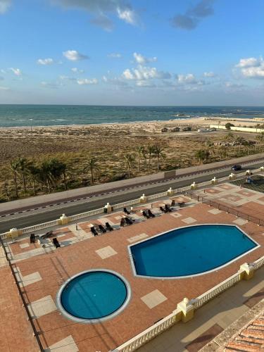 an overhead view of a swimming pool and the beach at Sweet Home Lagoon View in Ras al Khaimah