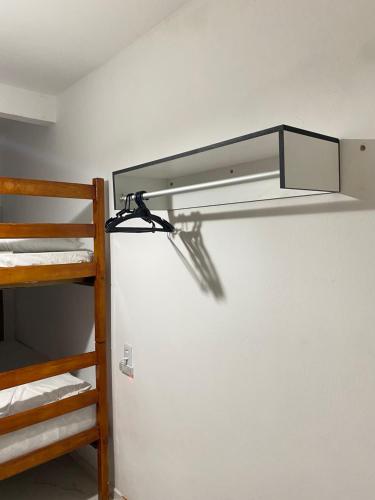 a light on a wall in a room with a bunk bed at Residence Brisa in Jericoacoara