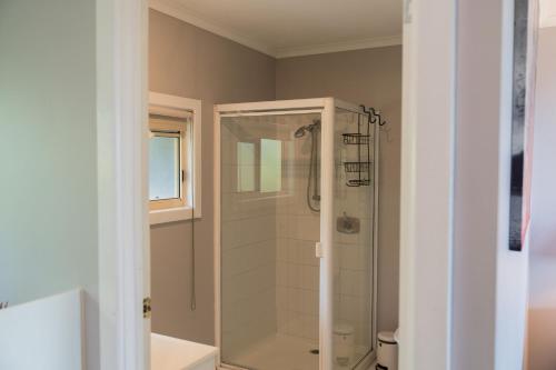 a bathroom with a shower with a glass at Sancerre Estate in Ballandean