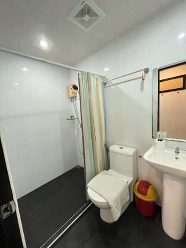 a bathroom with a toilet and a sink at Casita Isla Beach Inn in Boracay