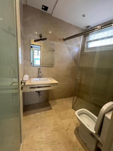 a bathroom with a toilet and a sink and a shower at Tingis Concept in Tangier