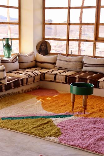 a couch in a living room with a rug at TOUGYA Ecolodge Near Agafay Desert in Marrakech