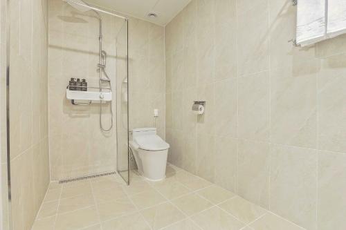 a bathroom with a shower and a toilet at Berith Hotel in Sokcho