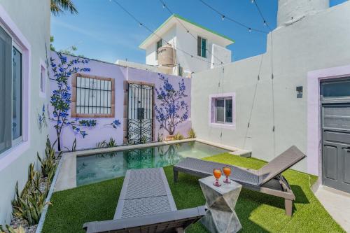 a villa with a swimming pool and a house at Casa Lila in Mérida