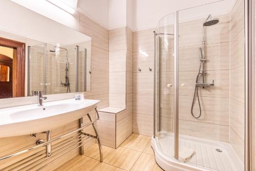 a bathroom with a sink and a shower at Hotel Arcade in Banská Bystrica