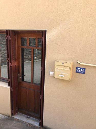 a door to a building with a mailbox next to it at Casa Lumos in Thizy-les-Bourgs