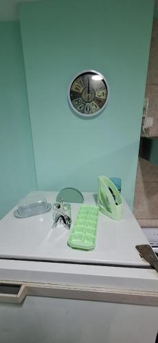 a bathroom sink with a clock on the wall at Departamento Dulce Adelina I - Zona Céntrica in Río Grande