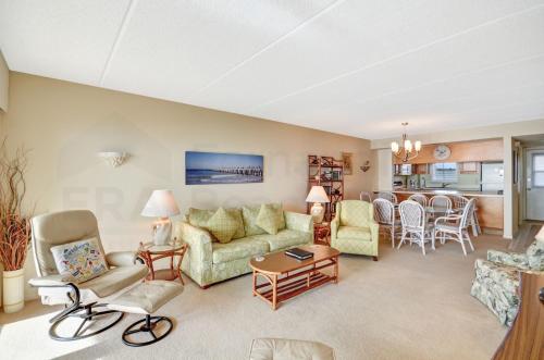 a living room with a couch and a table at Oceanview Amelia South Condo in Fernandina Beach
