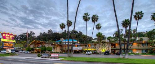a hotel with palm trees in front of a building at Kings Inn in San Diego
