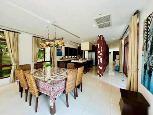 a dining room with a table and chairs at Amatapura Beachfront Villa 12, SHA Certified in Ao Nam Mao