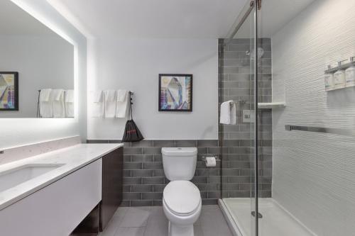 a bathroom with a toilet and a sink and a shower at Holiday Inn Express - Dallas Downtown by IHG in Dallas