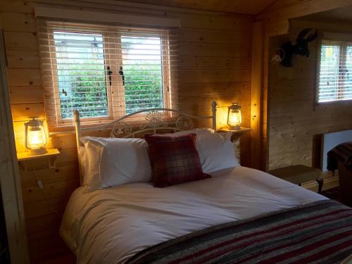 a bedroom with a white bed with two windows at Fourwinds B&B in March