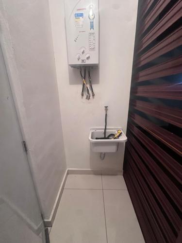 a small bathroom with a toilet with a sink at Brand New Beachfront Sunset Apartments in San Felipe de Puerto Plata