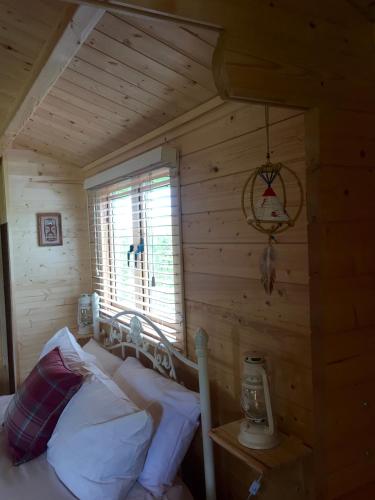 a bedroom with a bed in a log cabin at Fourwinds B&B in March