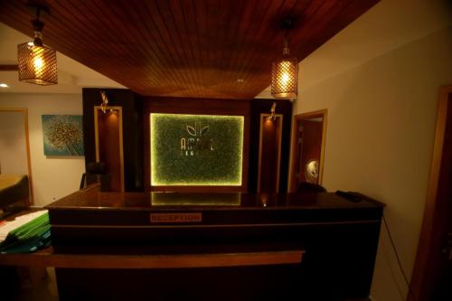 a room with a desk with a green picture on it at Ambal Regency in Pudukād