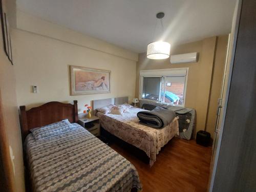 a bedroom with two beds and a window at Casa da lagoa com rampa para embarcações in Tramandaí