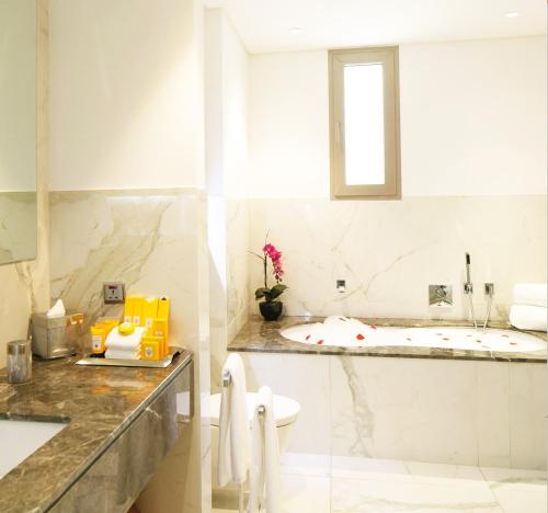 a white bathroom with a sink and a toilet at Vivienda Hotel Villas Granada in Riyadh