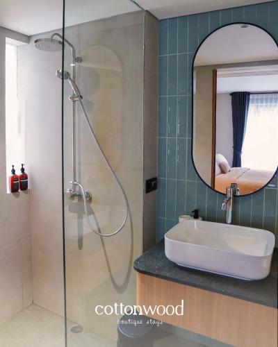 a bathroom with a sink and a shower with a mirror at Cottonwood Casarean Layar300inch Heated-Pool Billyard Api-Unggun in Tegalharendong