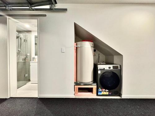 a kitchen with a drink mixer in a wall at Modern Brand New Luxury Retreat in Papatoetoe in Auckland