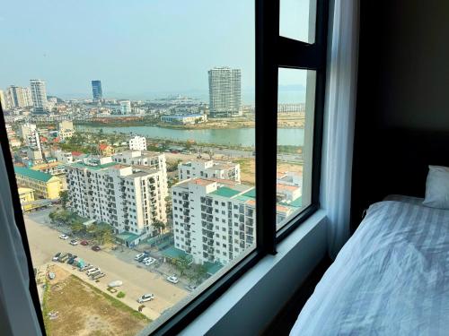 a bedroom window with a view of a city at Homestay Green Bay in Ha Long