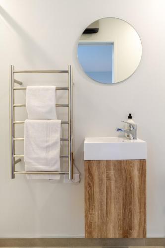 a bathroom with a sink and a mirror at Bright & Spacious 2BR near Ara Institute and CBD in Christchurch