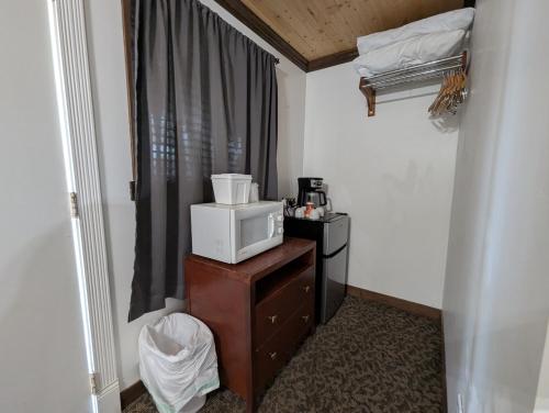 a room with a microwave on top of a dresser at Squaw Valley Motel Room 6 in Squaw Valley